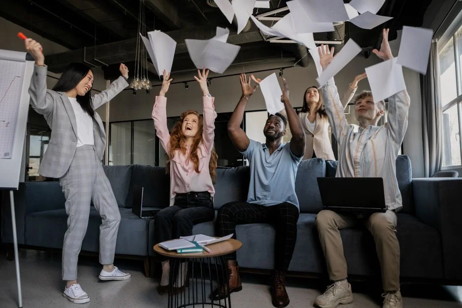 Overhead shot of diverse team analyzing marketing strategies with charts and graphs.